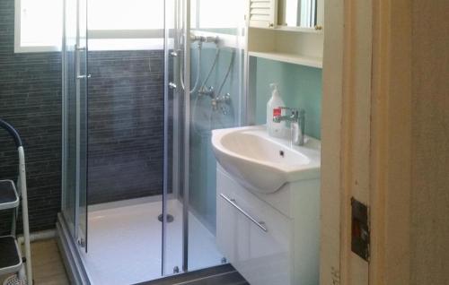 een badkamer met een wastafel en een glazen douche bij 3 Bedroom Beautiful Home In Vstervik in Västervik