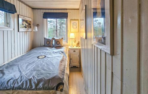 a small bedroom with a bed and a window at Nice Home In Stavern With Kitchen in Stavern