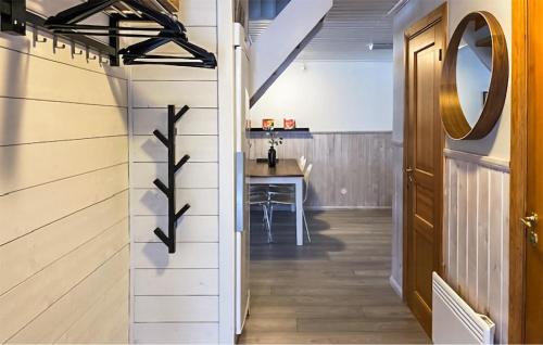 a hallway with a table and a mirror on the wall at Gorgeous Apartment In Sysslebäck in Sysslebäck