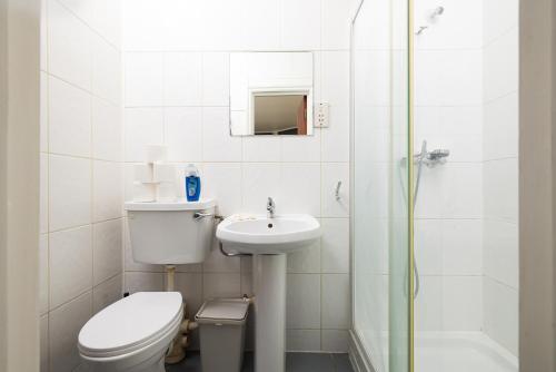 a bathroom with a toilet and a sink and a shower at Very Large Studio on Finchley Road 11 in London