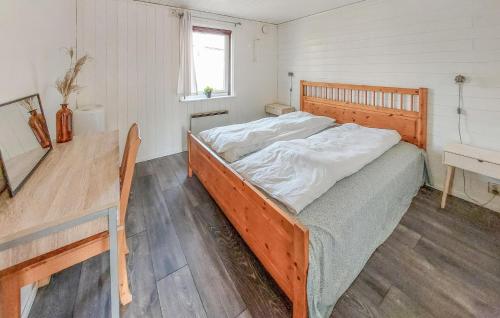 a bedroom with a bed and a wooden table at Amazing Home In Örkelljunga With Wifi in Orkelljunga