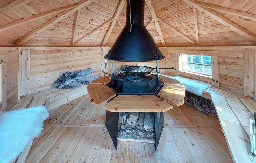 an inside view of a log cabin with a stove in it at Amazing Home In Örkelljunga With Wifi in Orkelljunga