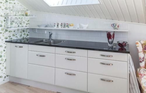 a kitchen with white cabinets and a sink at Pet Friendly Home In Alingss With Wifi in Alingsås