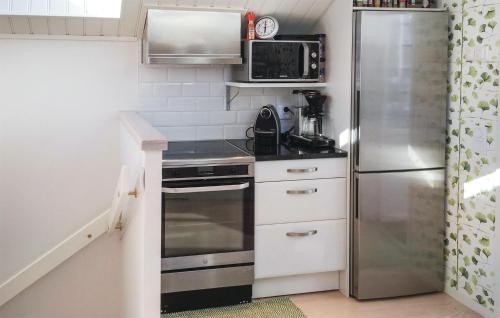a small kitchen with a stainless steel refrigerator at Pet Friendly Home In Alingsås With Wifi in Alingsås