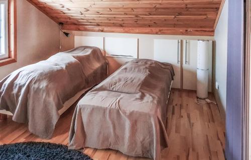 a bedroom with a bed and a wooden ceiling at 3 Bedroom Amazing Home In rjng in Årjäng
