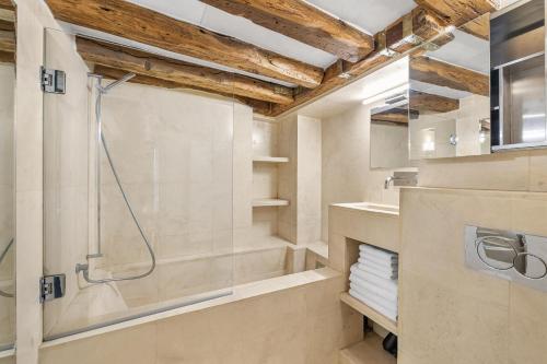 a bathroom with a shower and a sink at Caprice Amour in Paris