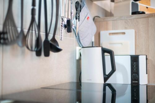 a kitchen counter with a coffee maker and utensils at FREE LIVING - City Design Apartments, Zentrum, Outlet, Balkon, Küche in Wolfsburg