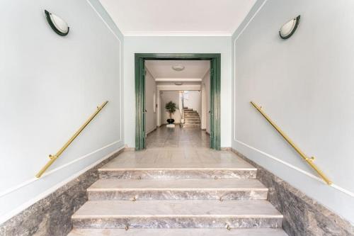 a hallway with stairs in a building at Amazing 3BDR Apt with Unique Roof Garden in Plaka in Athens