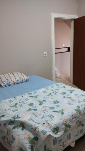 a bed with a blue comforter with animals on it at Pico do Jaraguá in São Paulo