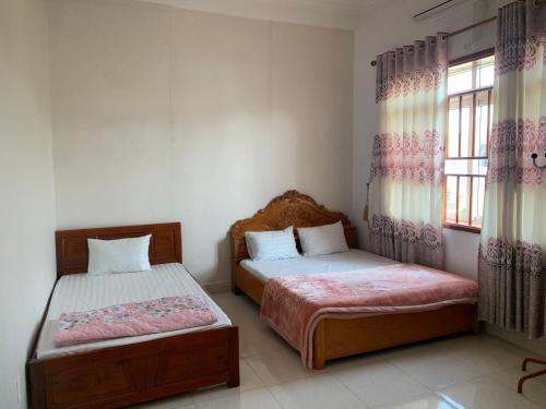 Posteľ alebo postele v izbe v ubytovaní Nhà Nghỉ Hải Nam