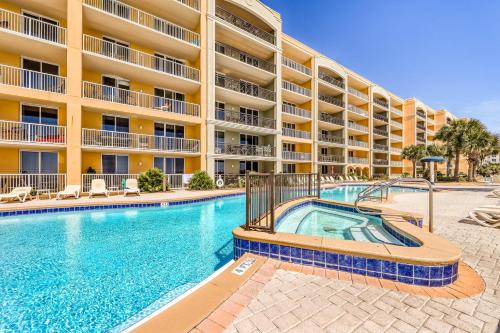 a swimming pool in front of a apartment building at Azure in Fort Walton Beach