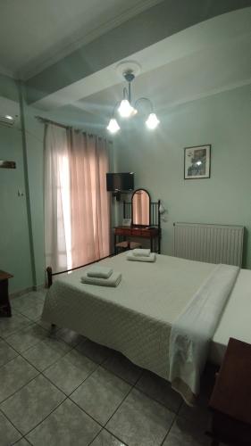 a bedroom with a large bed and a table at AGNANTIO in Monemvasia