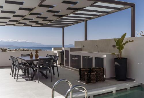 a patio with a table and chairs on a roof at Villa Aelia - With Private Pool & Sauna in Pigi