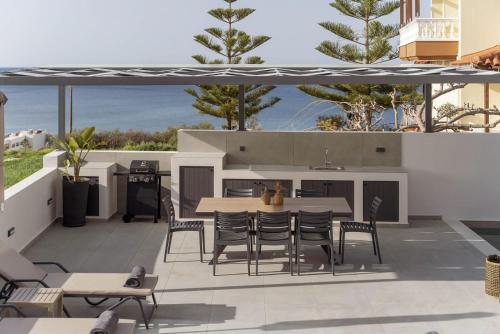 a patio with a table and chairs and a kitchen at Villa Aelia - With Private Pool & Sauna in Pigi