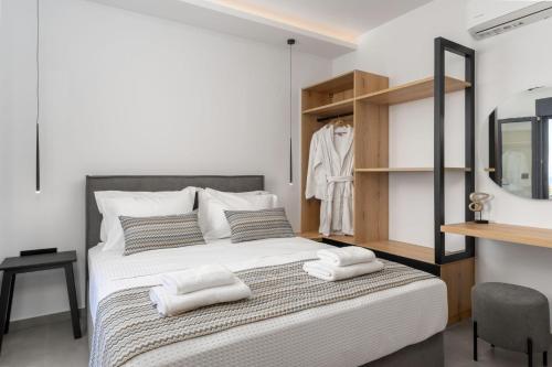 a bedroom with a bed with towels on it at Villa Aelia - With Private Pool & Sauna in Pigi