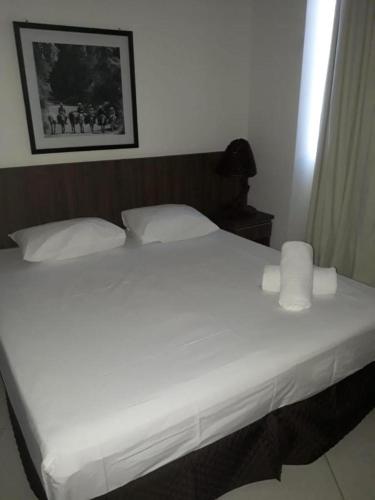 a bed with white sheets and pillows in a bedroom at 1233 in Barretos