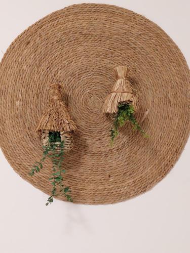 a brown straw hat with some plants on it at Pensión Cabezas in Lugones