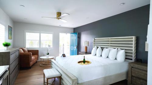 a bedroom with a large white bed with a blue wall at Ivory Sands Beach Suites in Clearwater Beach