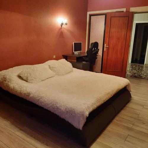 une chambre avec un lit et un bureau avec un ordinateur dans l'établissement Goutanou, à Châtillon-de-Michaille