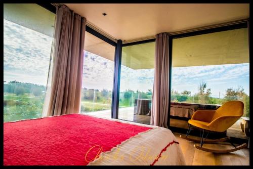 a bedroom with a red bed and a large window at Villa Cristal in Sète