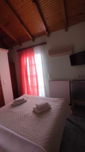 a bedroom with a bed with two towels on it at AGNANTIO in Monemvasia
