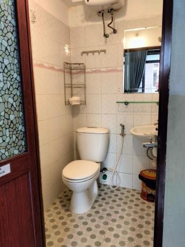 ein Badezimmer mit Toilette und Waschbecken in der Unterkunft RICE HOUSE HUE in Hue