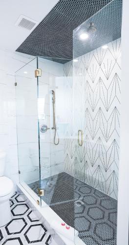 a bathroom with a glass shower with a toilet at Ivory Sands Beach Suites in Clearwater Beach