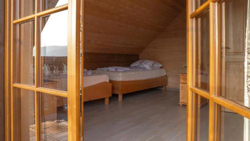 a bedroom with a bed in a wooden house at Jaworowa Osada in Brenna