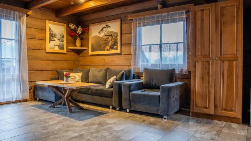 a living room with a couch and a table at Jaworowa Osada in Brenna