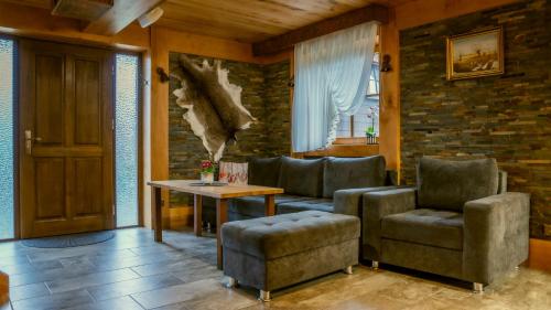 a living room with two chairs and a table at Jaworowa Osada in Brenna
