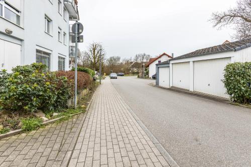 an empty street with a car driving down the street at Hotz in Radolfzell am Bodensee