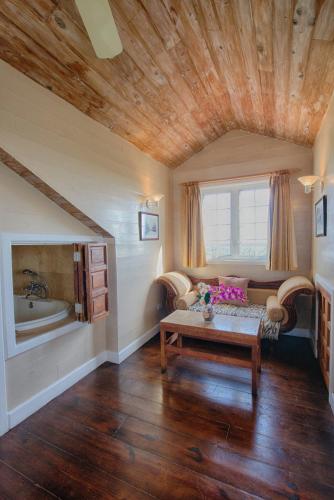 a living room with a wooden ceiling and a table at A Stone's Throw Away in Nassau