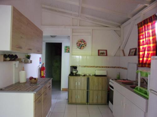 a kitchen with wooden cabinets and a counter top at  La kaz a coyoky in Anse-Bertrand