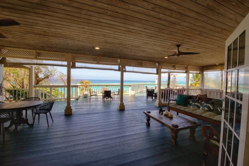 a screened in porch with a couch and a table at A Stone's Throw Away in Nassau