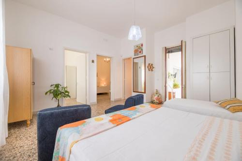a bedroom with two beds and two chairs at La Dimora Lucia by Paf in tour in Torre Suda