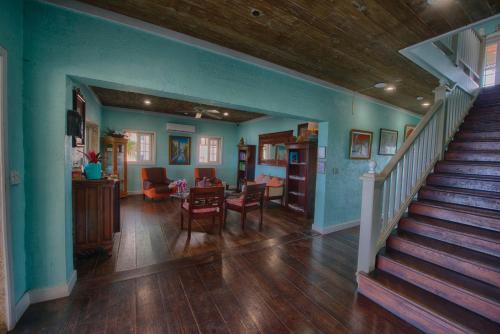 a living room with a staircase and a dining room at A Stone's Throw Away in Nassau