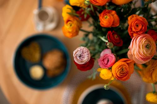 a vase filled with flowers on a table at Silvia’s Home in Monopoli