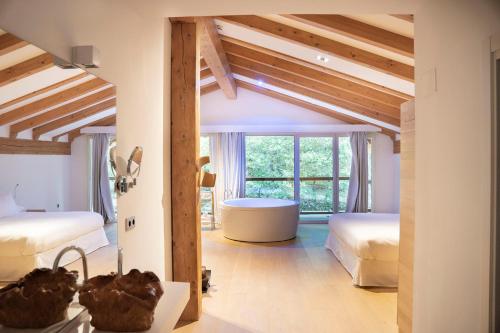 a bedroom with two beds and a large window at Arantza Hotela- Adults Only in Arantza