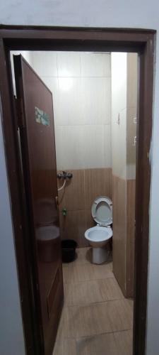 an open door to a bathroom with a toilet at New Arcadia Residence in Jakarta