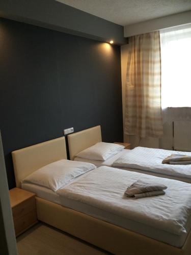 two beds sitting next to each other in a bedroom at Promohotel Slavie in Cheb