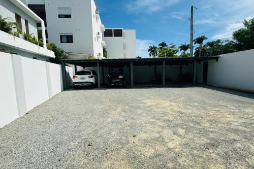 a car parked in a parking lot next to a building at Private Garden Villa With Parking in Las Terrenas