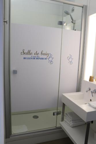 a bathroom with a shower and a sink at First Inn Hotel Blois in Blois