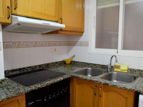 a kitchen with a sink and a counter top at Apartamentos Estacion Oropesa 3000 in Oropesa del Mar