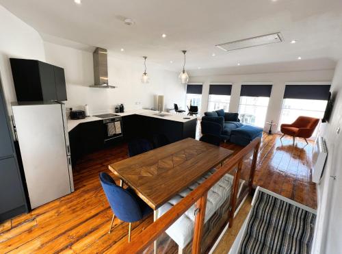 a kitchen and living room with a table and chairs at Cross Street Apartment in Ryde