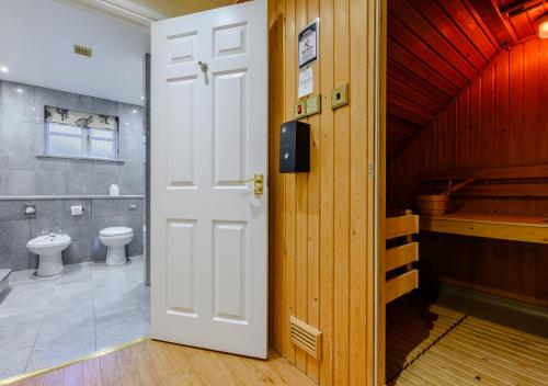 an open door to a bathroom with a toilet at Poppy Cottage - Cornwall in Saint Wenn