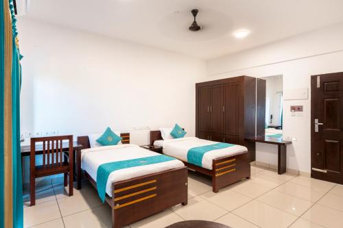 Postel nebo postele na pokoji v ubytování BnB Homes, Technopark, Trivandrum