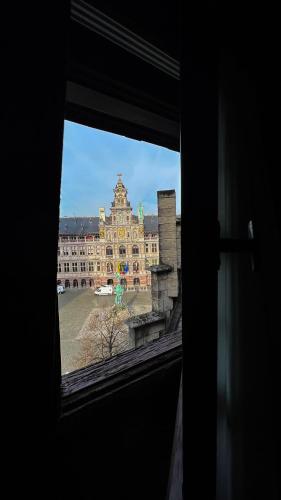 a view of a large building from a window at Le FauBourg Suites in Antwerp