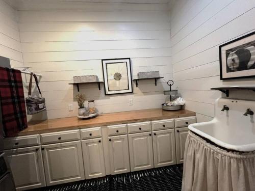 a bathroom with a counter and a sink in it at Southern Farm House 4 Br 4 Bath in Moultrie