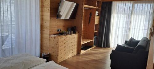 a bedroom with a bed and a television on a wall at Vetta Alpine Relax in Livigno