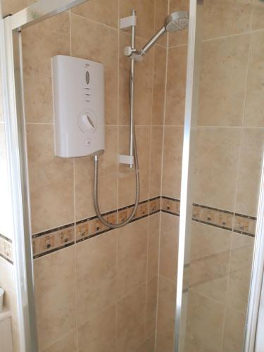 a shower in a bathroom with a shower head at The Barn - Quiet Location in Ashford